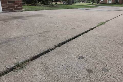 Concrete driveway slab settled below the next at the joint
