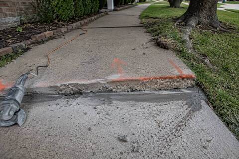 Sidewalk slab sitting higher than the panel next to it